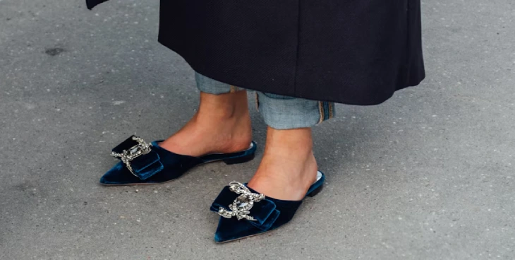 Women's Flats Business Names Ideas - a woman's feet wearing velvet navy blue flat shoes